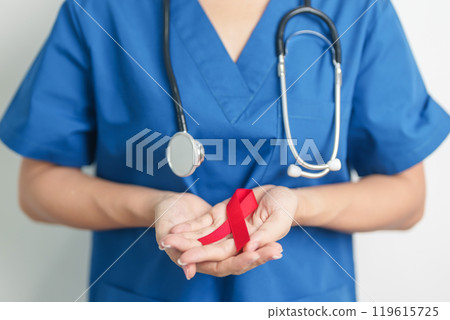 Doctor with Red Ribbon for December World Aids Day, acquired immune deficiency syndrome, multiple myeloma Cancer Awareness month and National Red ribbon week. Healthcare and world cancer day concept 119615725