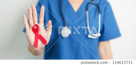 Doctor with Red Ribbon for December World Aids Day, acquired immune deficiency syndrome, multiple myeloma Cancer Awareness month and National Red ribbon week. Healthcare and world cancer day concept 119615731