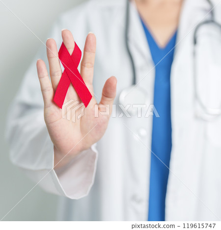 Doctor with Red Ribbon for December World Aids Day, acquired immune deficiency syndrome, multiple myeloma Cancer Awareness month and National Red ribbon week. Healthcare and world cancer day concept 119615747