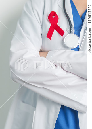 Doctor with Red Ribbon for December World Aids Day, acquired immune deficiency syndrome, multiple myeloma Cancer Awareness month and National Red ribbon week. Healthcare and world cancer day concept 119615752