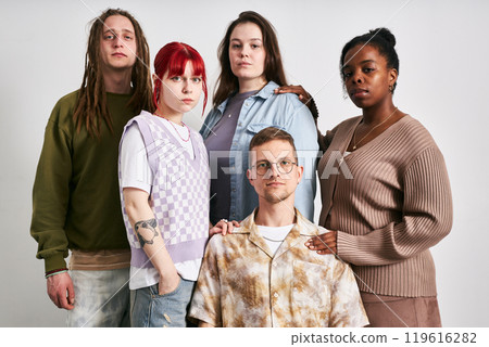 Portrait of group of five young adults of diverse ethnic backgrounds standing together against neutral background, showcasing various styles and personalities Portrait of group of five young adults of diverse ethnic backgrounds standing together against neutral background, showcasing various styles and personalities 119616282
