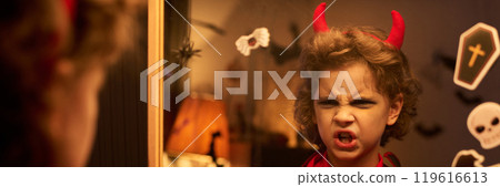 Little boy in demon costume scowling Little boy in demon costume scowling 119616613