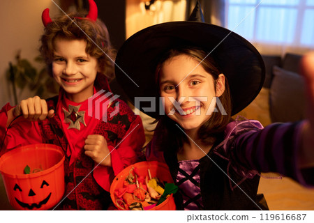 Cute kids smiling while taking selfie Cute kids smiling while taking selfie 119616687