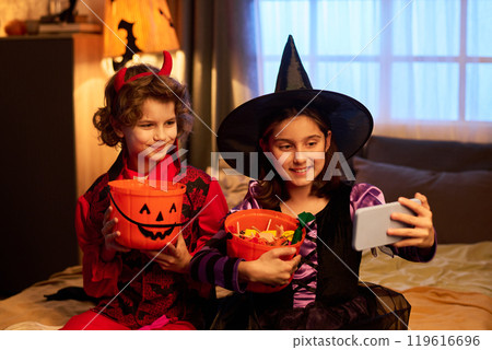 Kids with Halloween treats taking selfie Kids with Halloween treats taking selfie 119616696