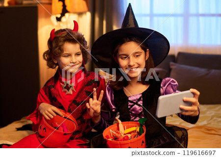 Youthful kids in Halloween costumes 119616697