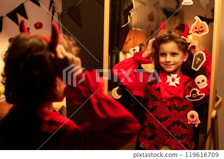 Child getting ready for Halloween party 119616709