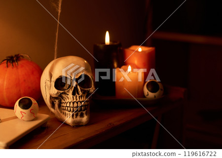Human skull, eyes, pumpkin and candles Human skull, eyes, pumpkin and candles 119616722