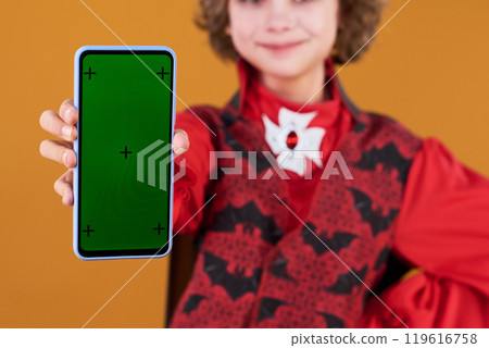 Hand of Halloween boy with mobile phone 119616758