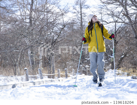 Woman enjoying winter leisure Woman enjoying winter leisure 119618204