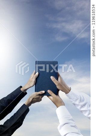Man holding a holy bible in his hand together. Symbol of faith and worship in God. People christianity prayer Man holding a holy bible in his hand together. Symbol of faith and worship in God. People christianity prayer 119618534