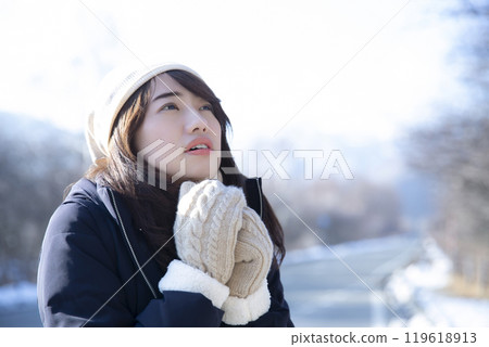 A woman wearing gloves on a cold day 119618913