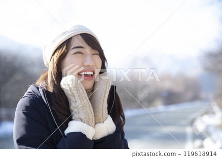 A woman wearing gloves on a cold day 119618914