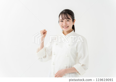 Woman in chef's coat, fist pump Woman in chef's coat, fist pump 119619091