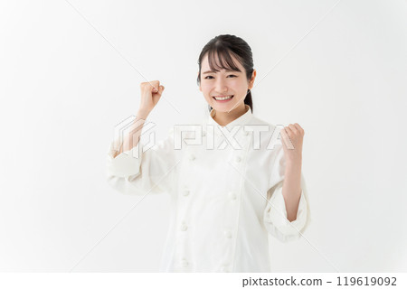 Woman in chef's coat, fist pump Woman in chef's coat, fist pump 119619092