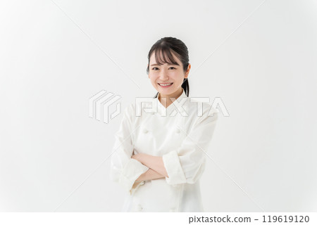 Woman in chef's coat with arms crossed 119619120