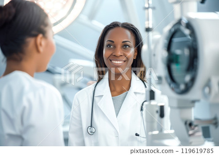 Smiling female doctor engaging with patient in modern medical clinic 119619785