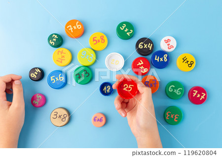 fun times tables games for kids, learning multiplication facts, times tables using bottle caps with multiplication exercises on blue background, practice, 119620804