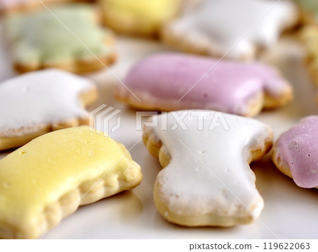 Four colored icing cookies on a white plate Four colored icing cookies on a white plate 119622063