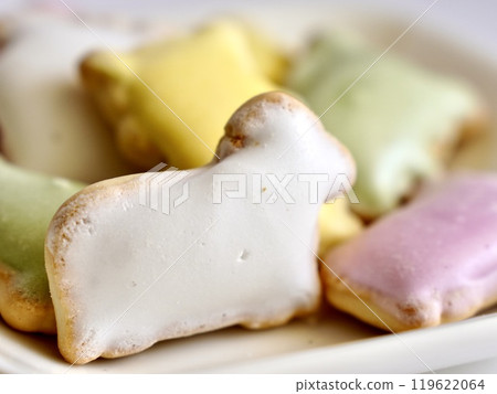 Four colored icing cookies on a white plate Four colored icing cookies on a white plate 119622064