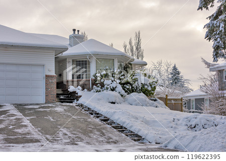 Big residential house with rotonda in snow on overcast winter day Big residential house with rotonda in snow on overcast winter day 119622395