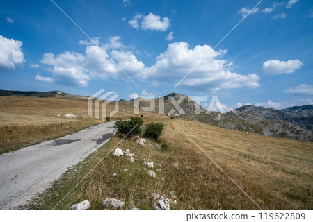 Country road winding through hills and mountains. Durmitor National Park Country road winding through hills and mountains. Durmitor National Park 119622809