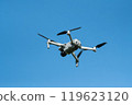 Drone Flying in Clear Blue Sky 119623120