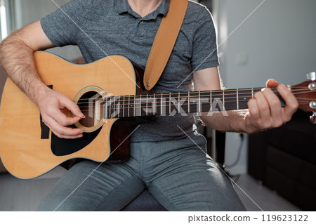 Guitarist on acoustic guitar playing melody. Close up musician instrument 119623122