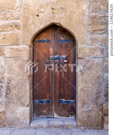 Exploring the Ancient Wooden Door of the Ateshgah Fire Temple in Baku, Azerbaijan During a Sunny Day 119623429