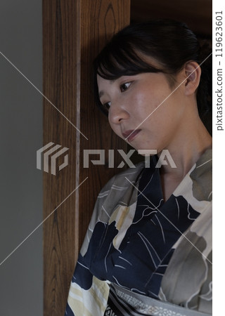 A young woman in a yukata in a Japanese-style room A young woman in a yukata in a Japanese-style room 119623601