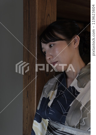 A young woman in a yukata in a Japanese-style room A young woman in a yukata in a Japanese-style room 119623604