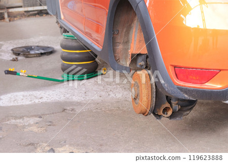 Car repair. Wheel balancing or repair and change auto tire. Technicians are fixing wheel in garage. Car repair. Wheel balancing or repair and change auto tire. Technicians are fixing wheel in garage. 119623888