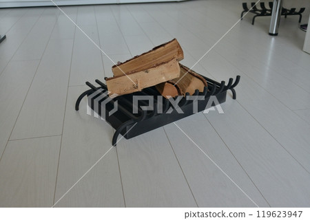 An object photo shoot of black grilles for fireplaces on a light background in the interior. 119623947