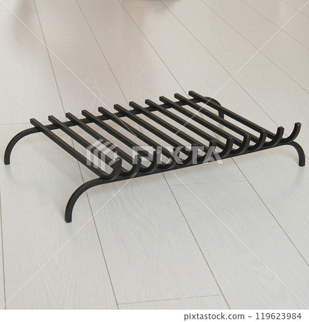An object photo shoot of black grilles for fireplaces on a light background in the interior. 119623984