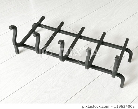 An object photo shoot of black grilles for fireplaces on a light background in the interior. 119624002