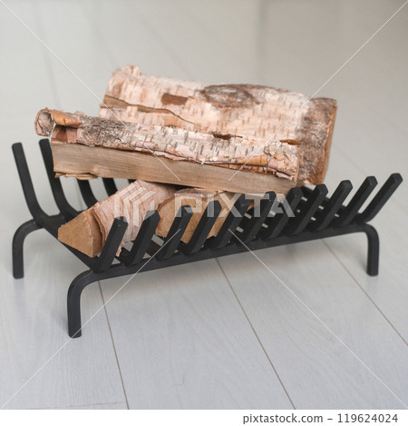 An object photo shoot of black grilles for fireplaces on a light background in the interior. 119624024