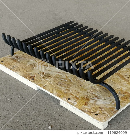An object photo shoot of black grilles for fireplaces on a light background in the interior. 119624099