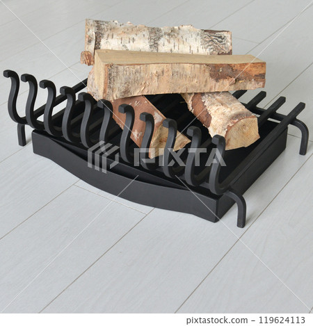 An object photo shoot of black grilles for fireplaces on a light background in the interior. An object photo shoot of black grilles for fireplaces on a light background in the interior. 119624113
