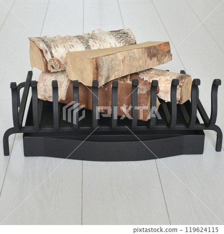 An object photo shoot of black grilles for fireplaces on a light background in the interior. An object photo shoot of black grilles for fireplaces on a light background in the interior. 119624115