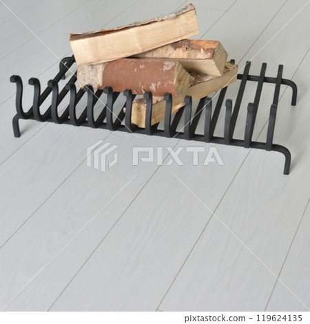 An object photo shoot of black grilles for fireplaces on a light background in the interior. 119624135