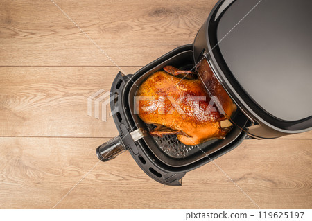roasted duck garnished made in the air fryer. festive holiday meal, top view. copy space 119625197