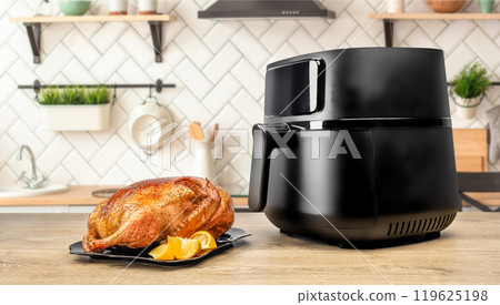 roasted whole baked duck with orange cooked in an air fryer in the kitchen 119625198