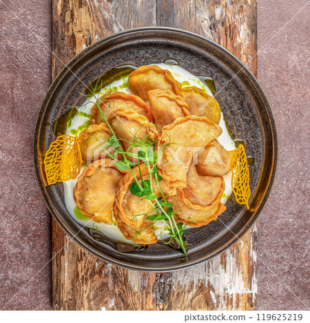 Ukrainian dish varenyky, vareniki, pierogi, pyrohy with sour cream sauce. top view 119625219