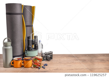 healthy snack of tourists with different camping equipment on a wooden board. food for the trip isolated on white 119625257