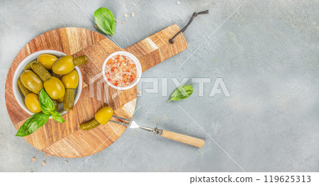 Green olives stuffed with cucumbers on a wooden board. banner, menu, recipe place for text, top view 119625313
