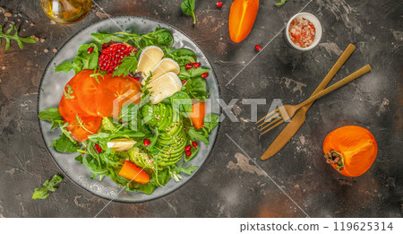 Persimmon salad with fresh greens, avocado, Camembert cheese and pomegranate Persimmon salad with fresh greens, avocado, Camembert cheese and pomegranate 119625314