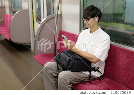 Man on train, smartphone, music Man on train, smartphone, music 119625629