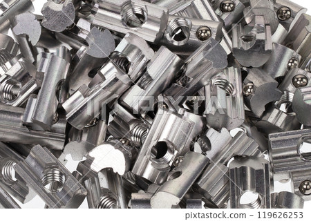 Pile of metal threaded nuts with ball bearings 119626253