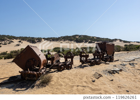 Abandoned rusty mining carts on a desert landscape Abandoned rusty mining carts on a desert landscape 119626261
