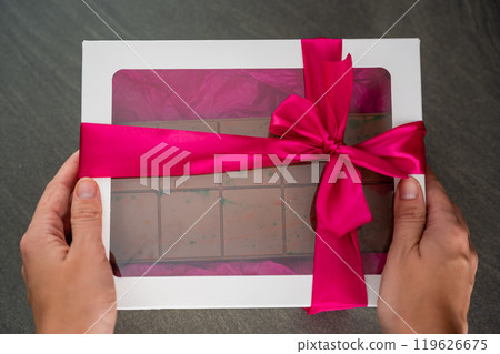 Trend Dubai chocolate with pistachio paste and kataifi dough in present box. Confectionery handmade sweets at home in the kitchen.  Trend Dubai chocolate with pistachio paste and kataifi dough in present box. Confectionery handmade sweets at home in the kitchen.  119626675