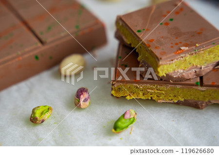 Trend Dubai chocolate with pistachio paste and kataifi dough. Confectionery handmade sweets at home in the kitchen. Trend Dubai chocolate with pistachio paste and kataifi dough. Confectionery handmade sweets at home in the kitchen. 119626680